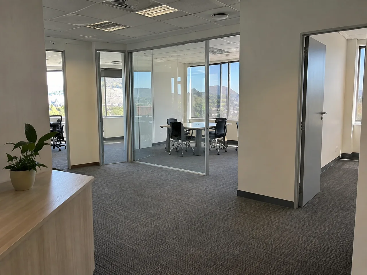 Office corridor and glass-partitioned meeting room